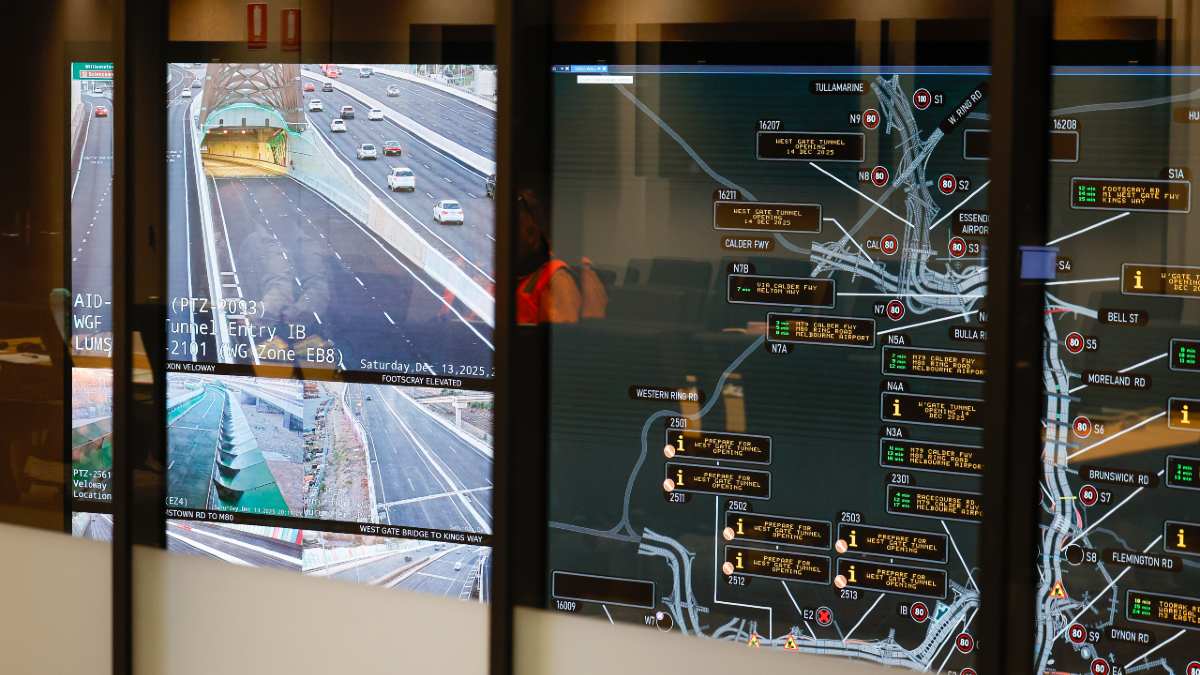 A route 75 tram travelling down a busy road in Melbourne