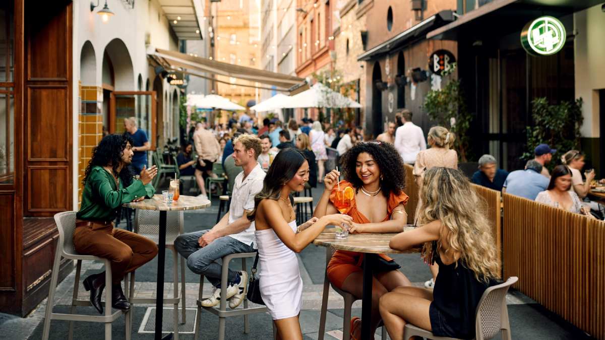 many people dining at outdoor tables on Adelaide's Peel Street