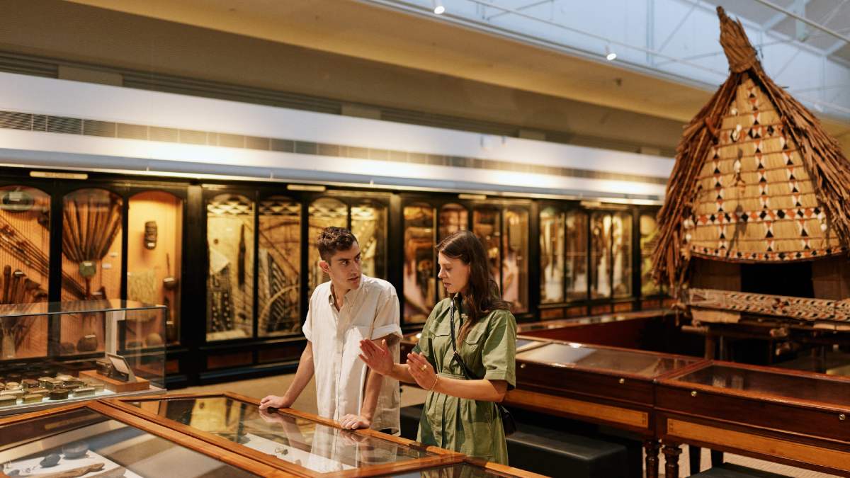 woman talking to man about a museum display