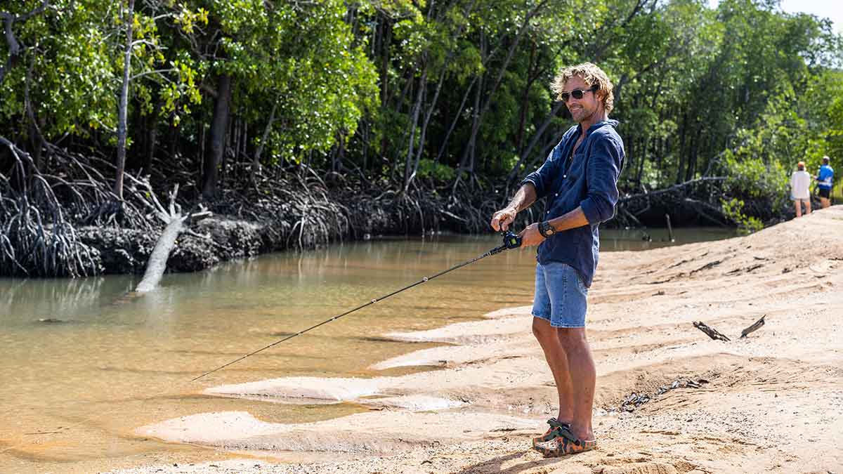 Man fishing on river bank in Northern Territory