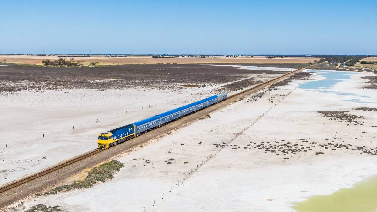 passenger train crossing a dry salt lake