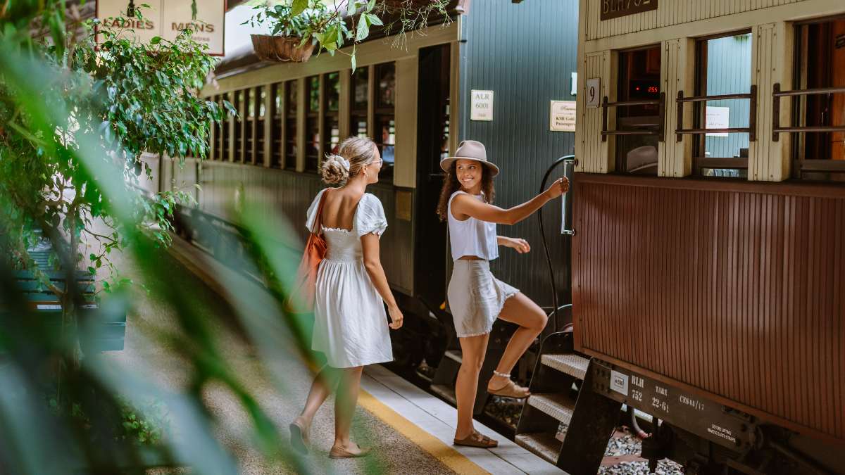 two young women climbing aboard a train