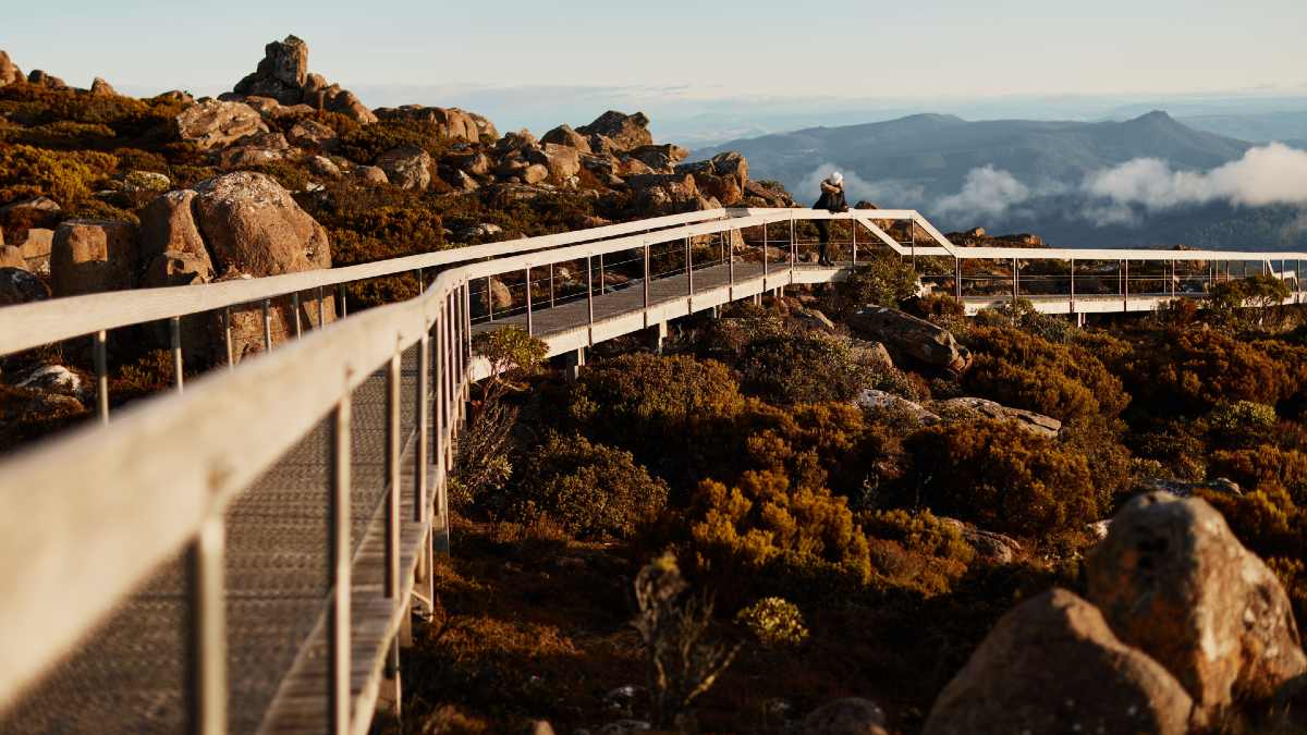 woman standing at mountain summit