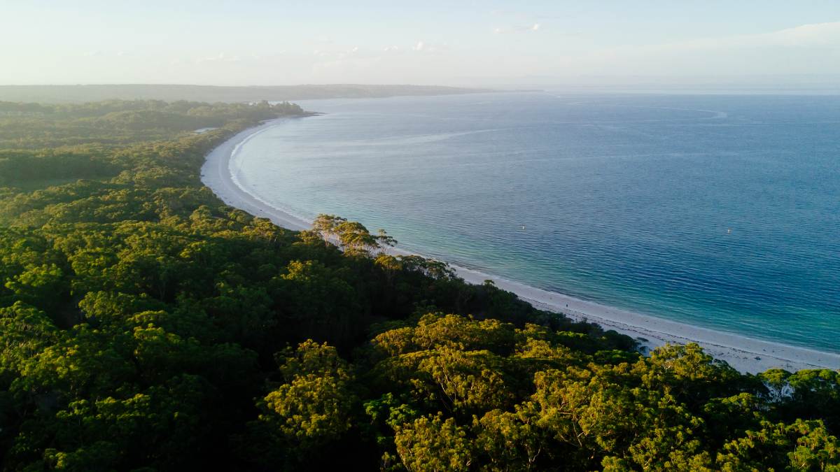 aerial landscape shot of Jervis Bay: ocean and white sand then trees
