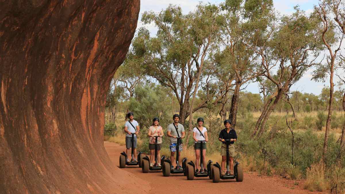 group of tourists and guide on segways at Uluru