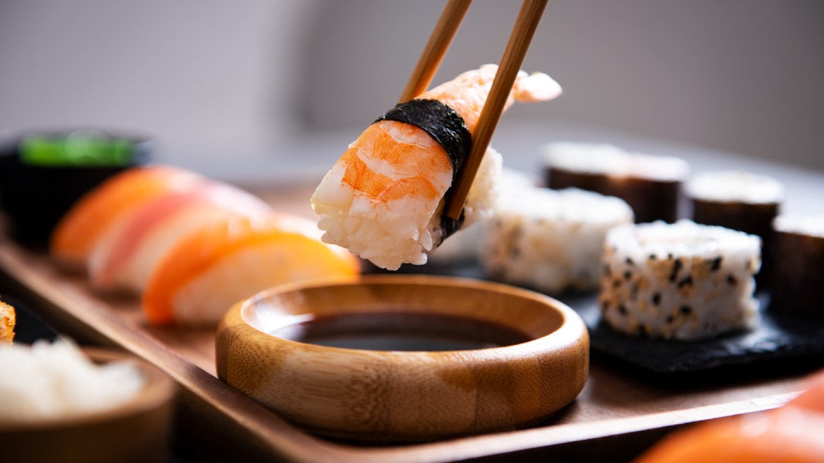 sushi piece being picked up with chopsticks