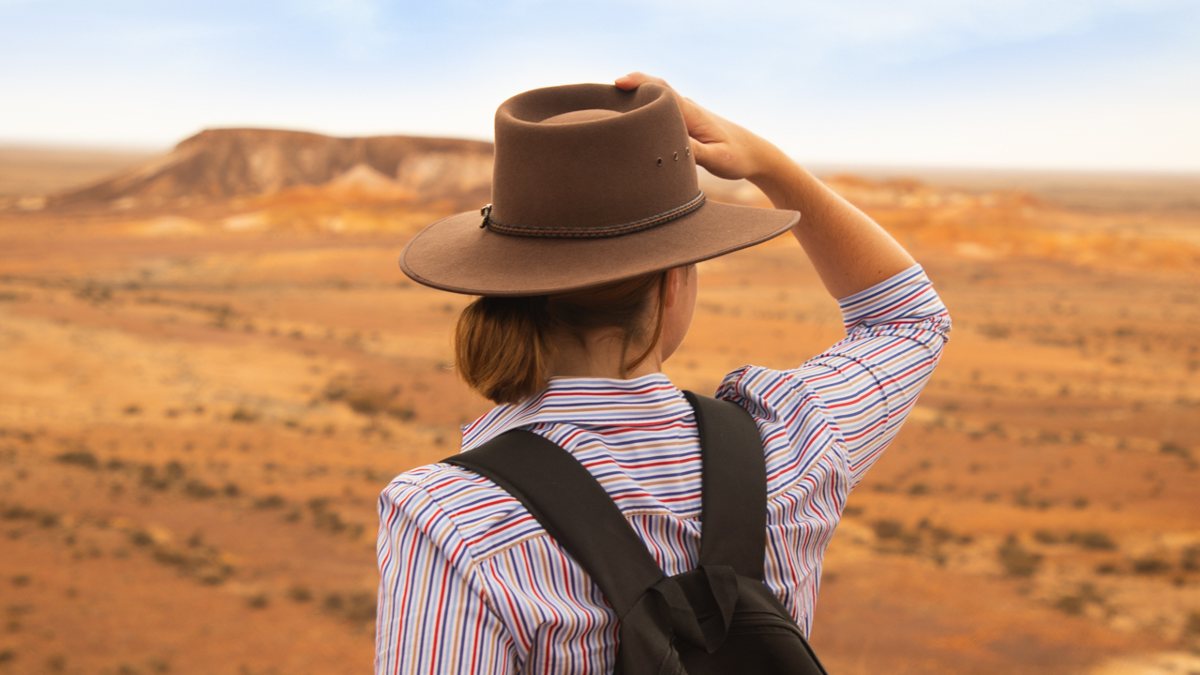 woman looking over dry yellow landscape