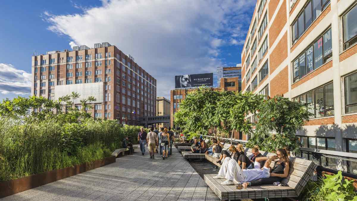people walking and lounging on an elevated pathway