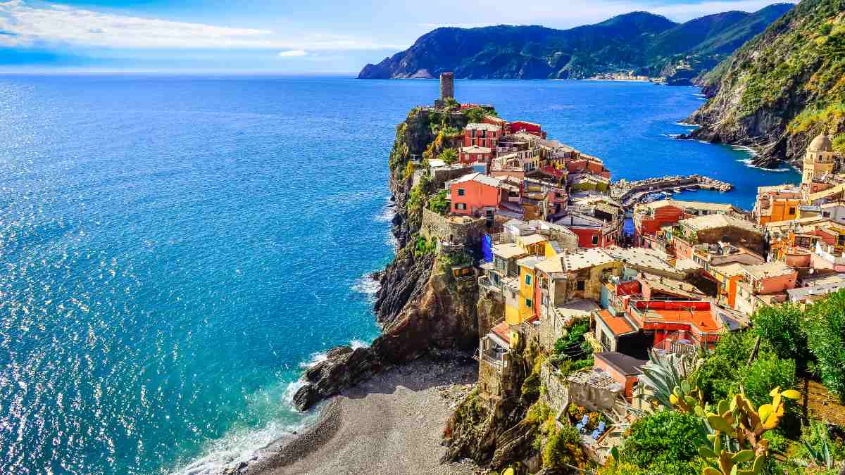 sunlit brightly coloured Vernazza town by ocean