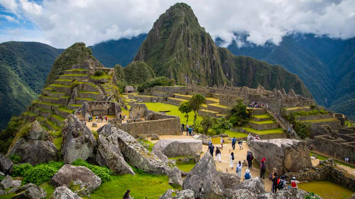 tourists wandering around the Machu Picchu ruins