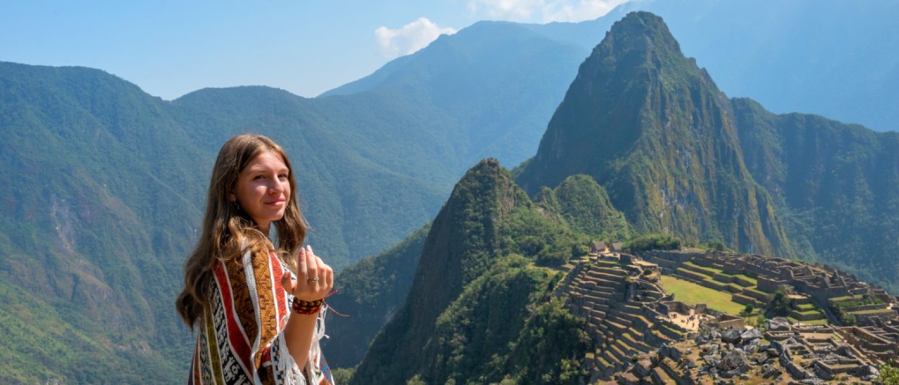 Machu Picchu, Peru_Getty young woman wearing shawl with Machu Picchu in background