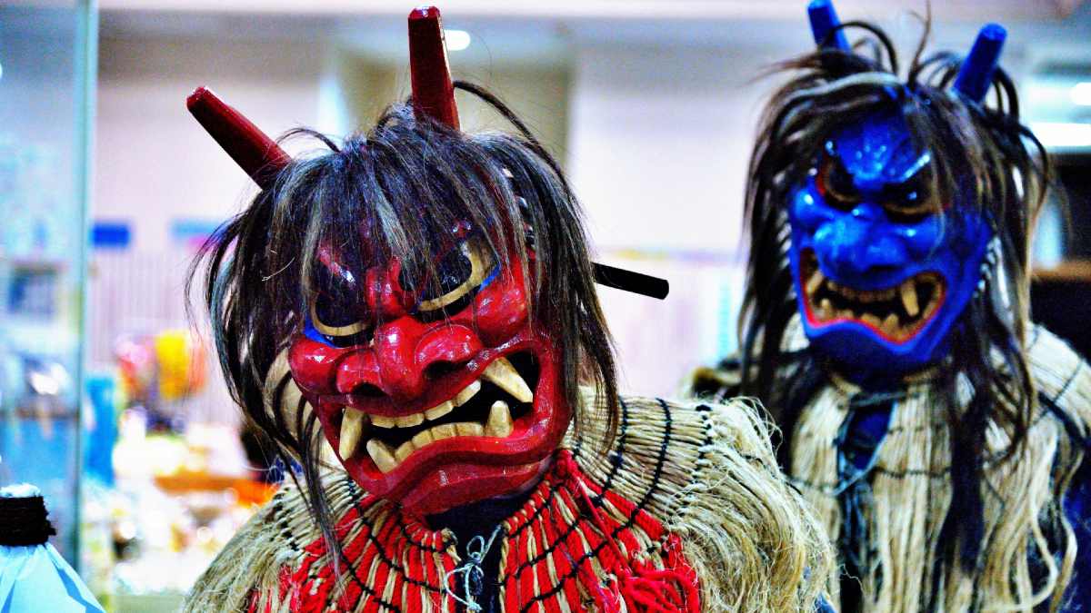 two people dressed in namahage costumes
