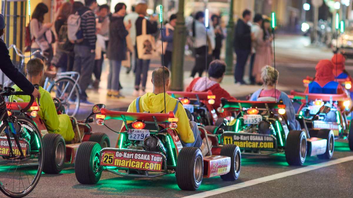 tourists in Mario Kart costumes riding go-karts in Osaka