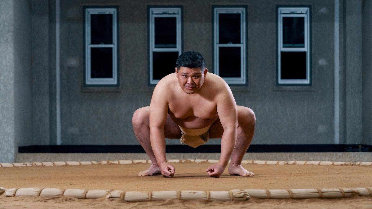 young sumo wrestler crouching