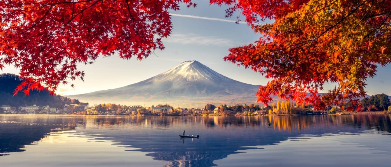 Lake Kawaguchiko, Japan_Getty man on boat on Lake Kawaguchiko with Mt Fuji in the background
