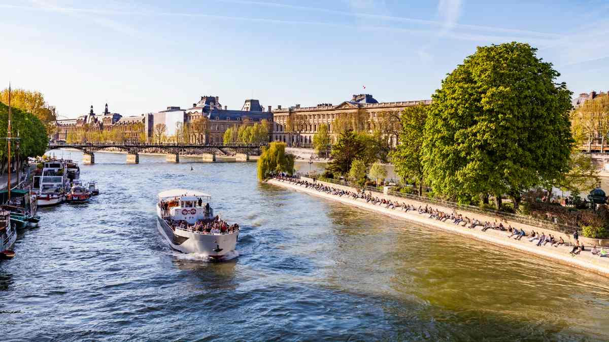 boat with passengers cruising down the Seine in Paris
