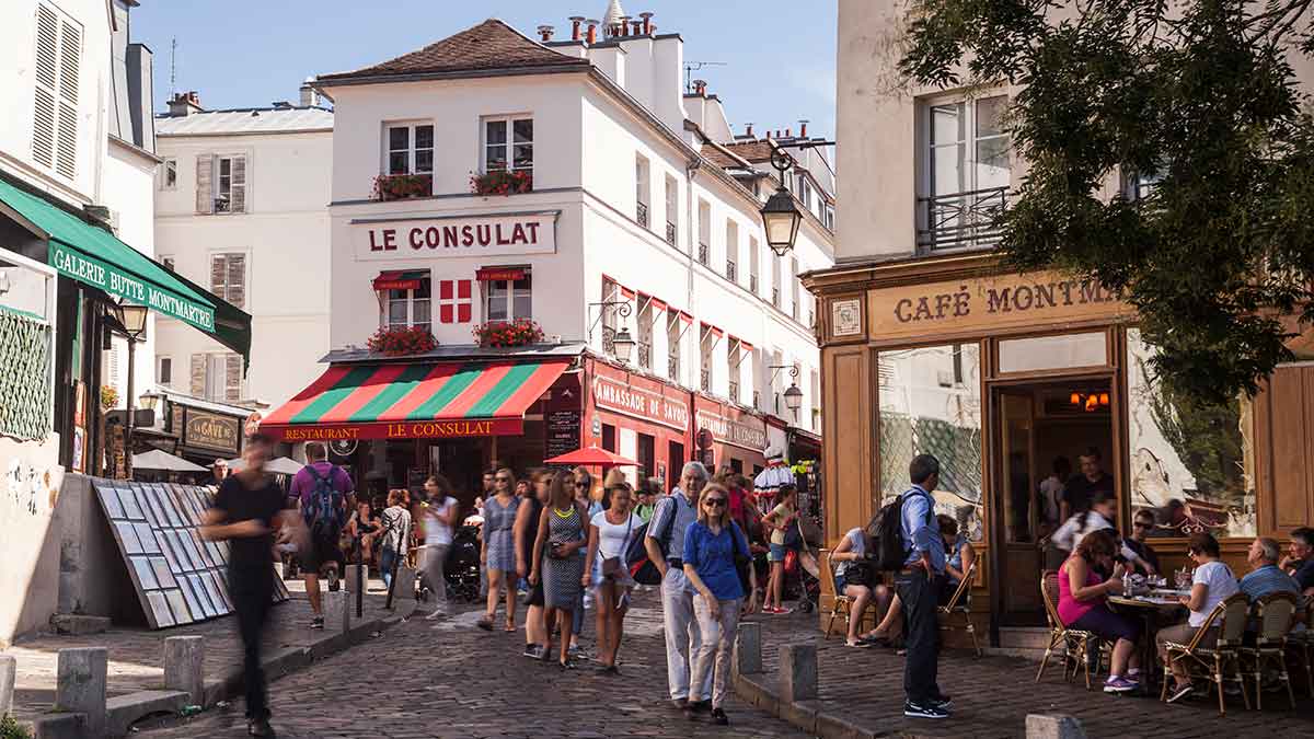Busy street with cafes in Montmartre in Paris.