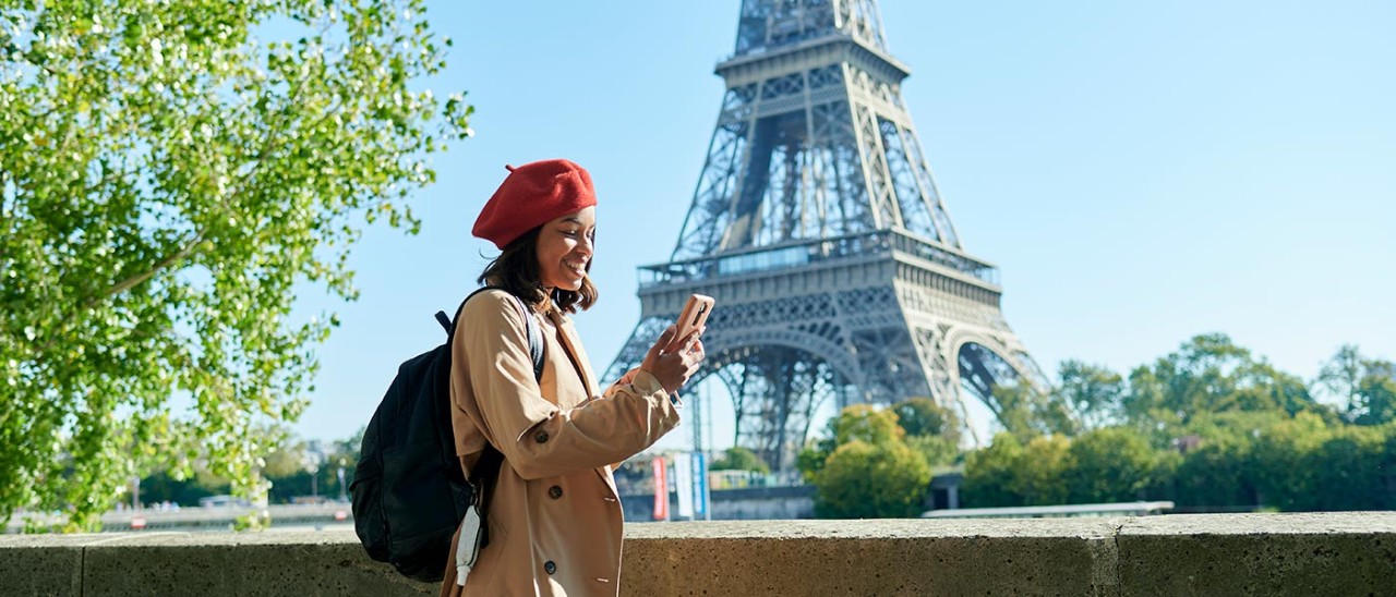 Paris-woman-and-eiffel-tower-Getty-1350916834-1400x600.jpg Woman walking along bridge in Paris with Eiffel Tower in background.