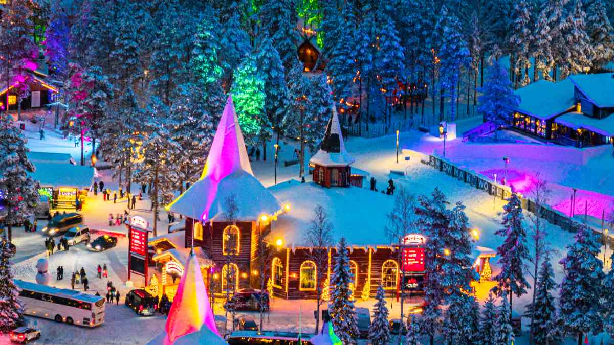 brightly lit village covered in snow