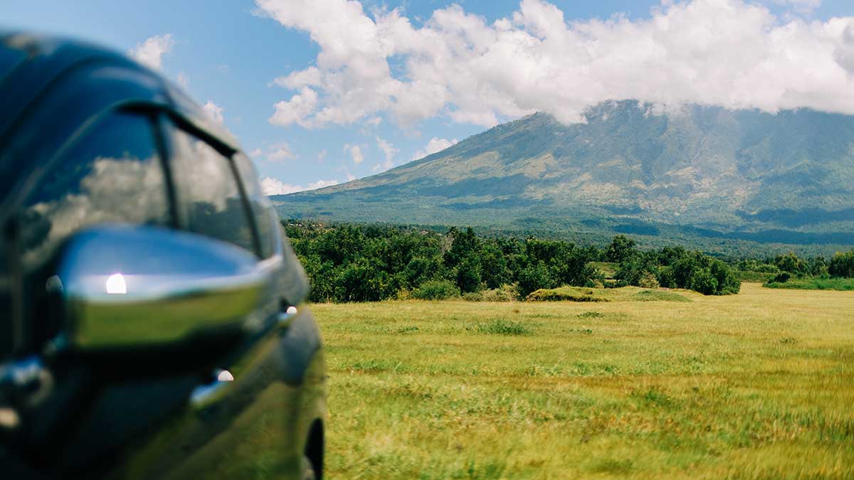  Road trip in Bali with car parked by Mount Agung.