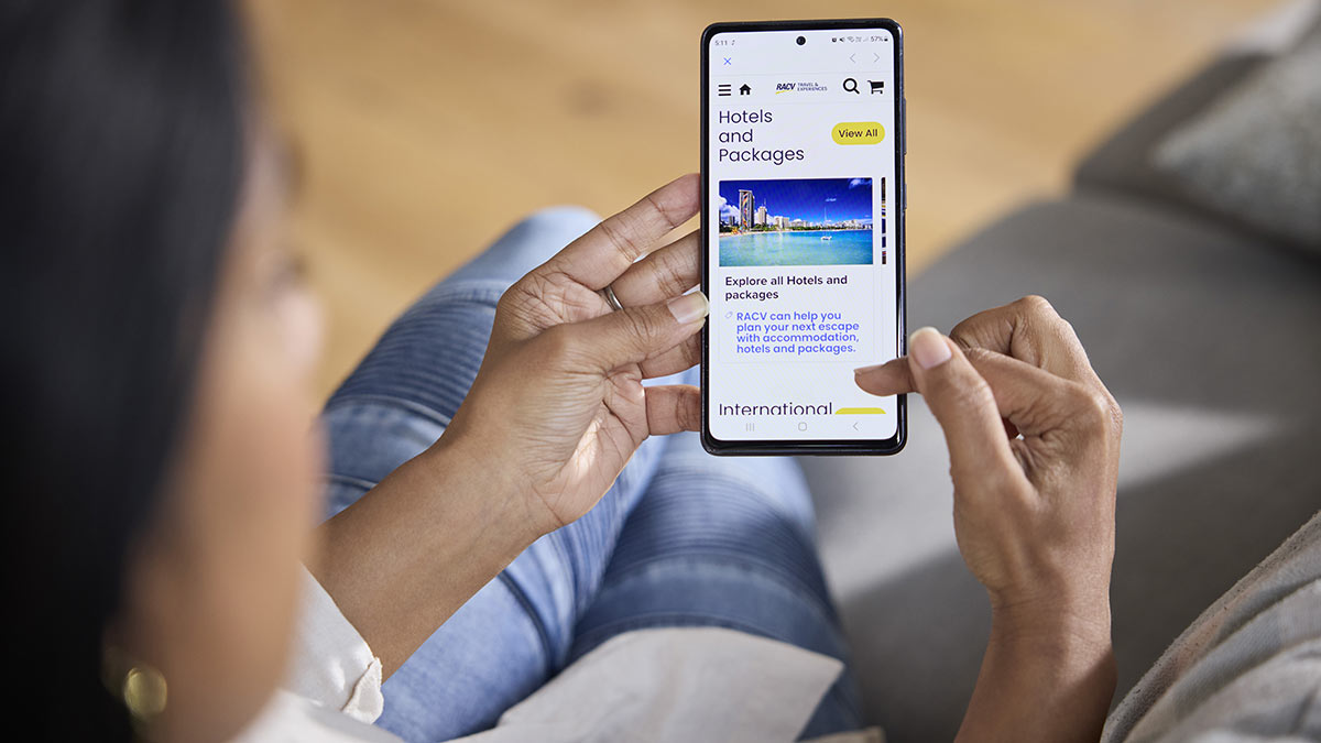 Woman looking at RACV Travel and Experiences hotel booking page via the RACV App