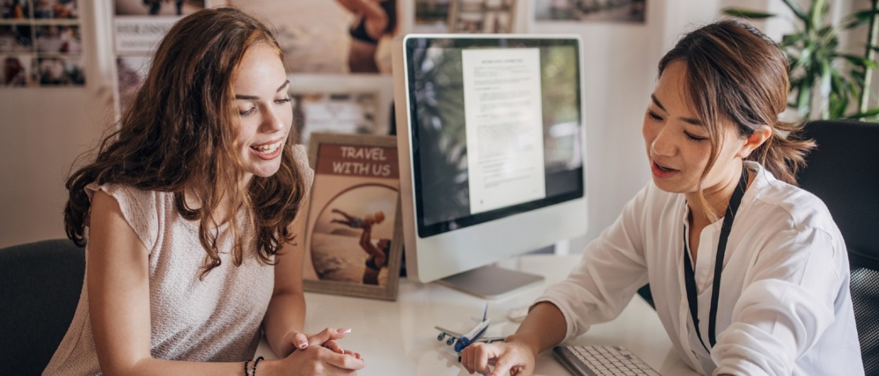 travel agent showing client travel information