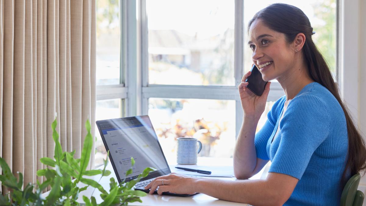 woman making a phone call while on her laptop