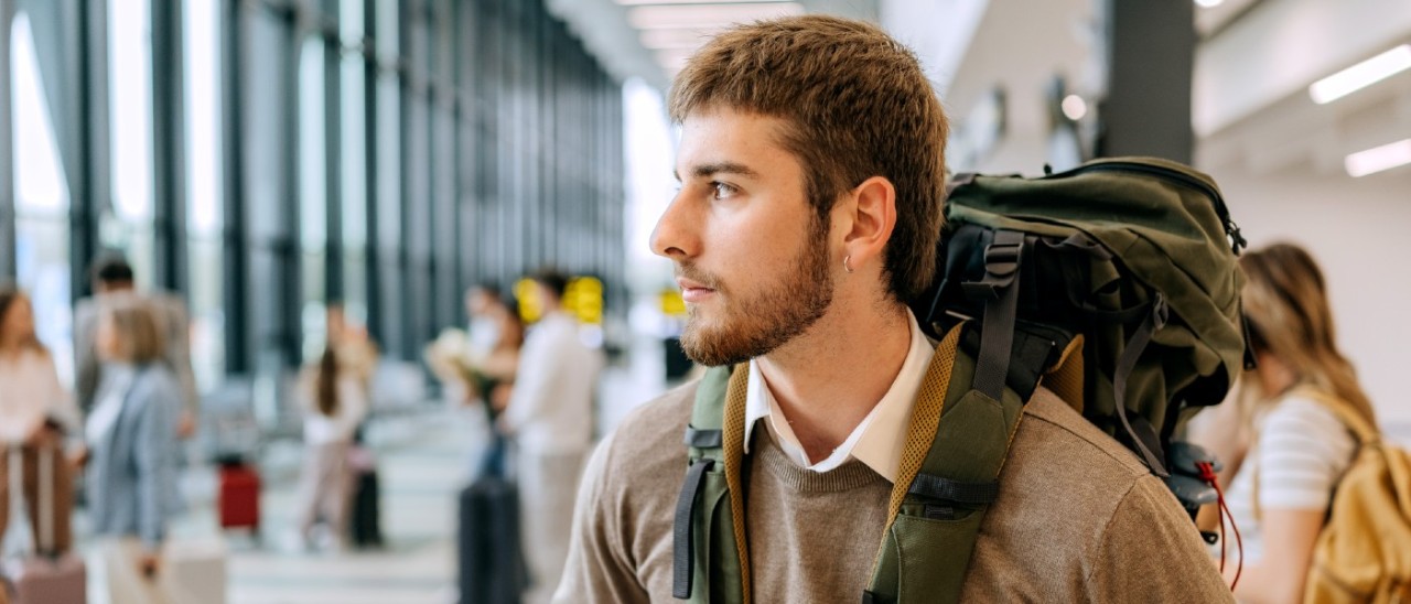 young male backpacker at airport