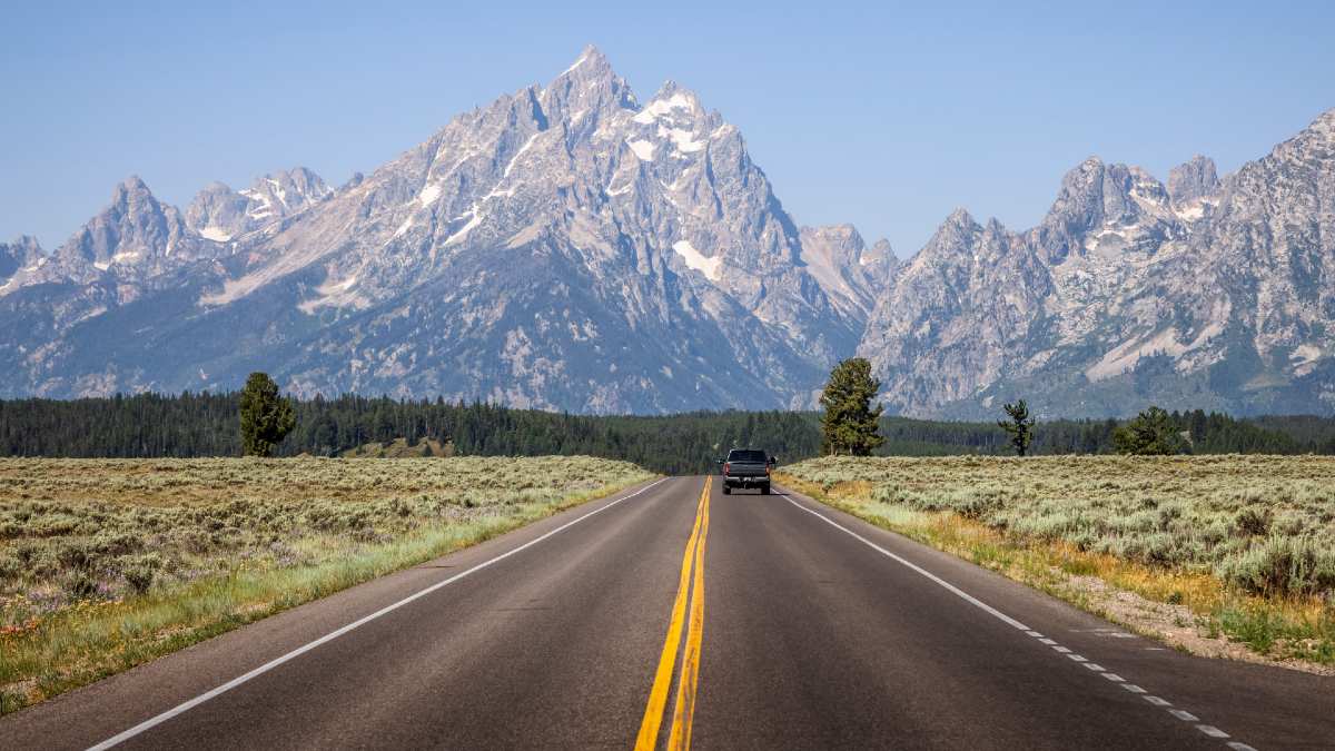 car driving on road with mountains in background in the USA