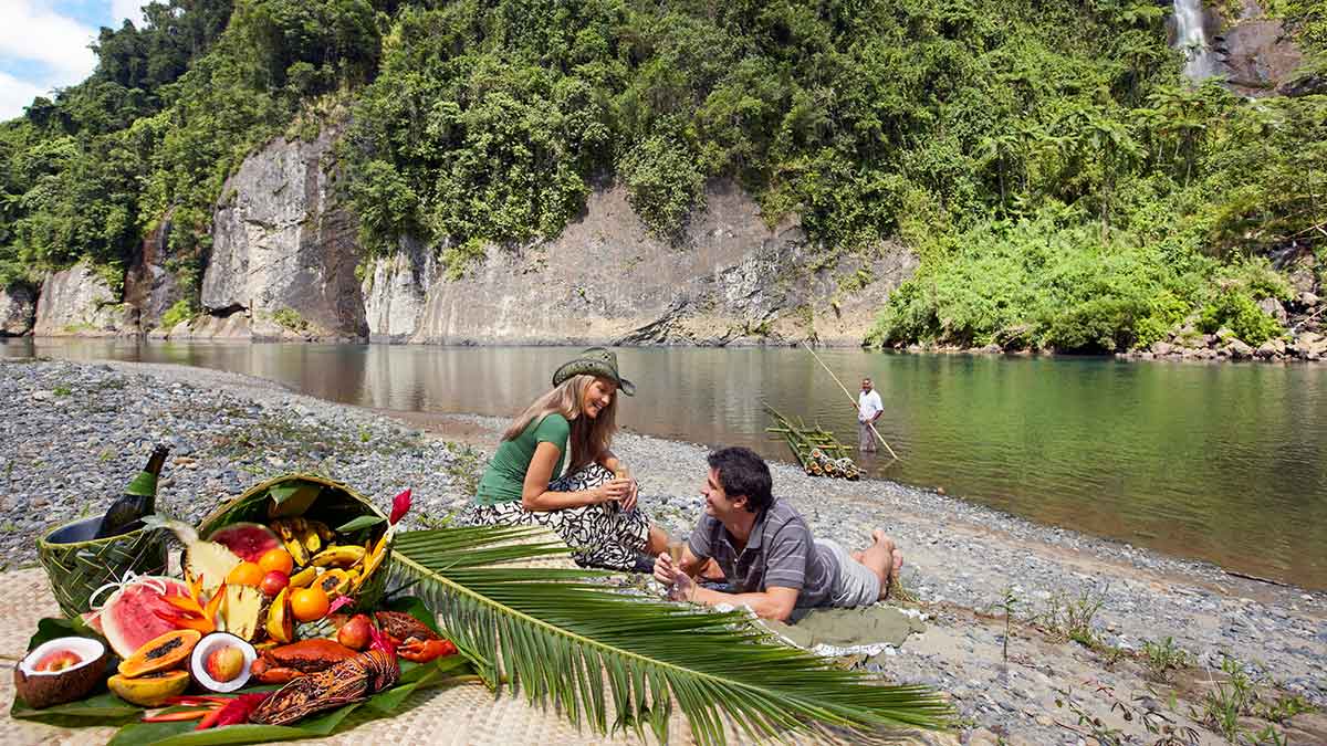 couple having a riverside picnic in Fiji