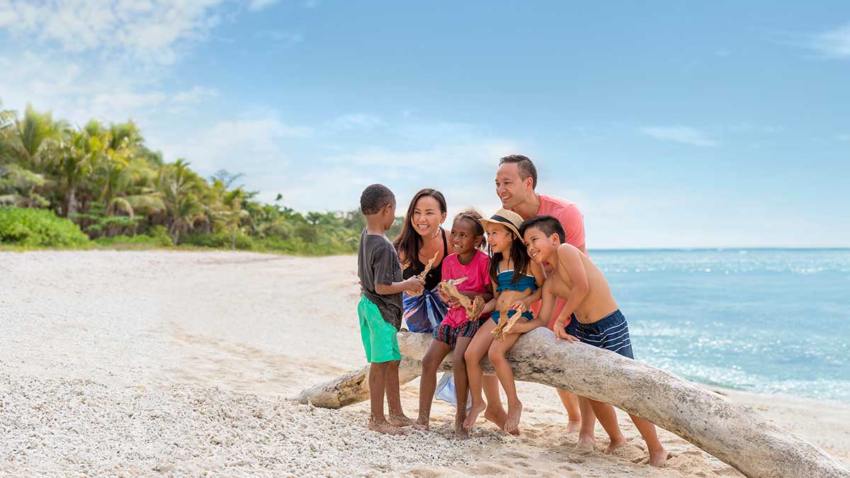 family of six on a Fijian beach