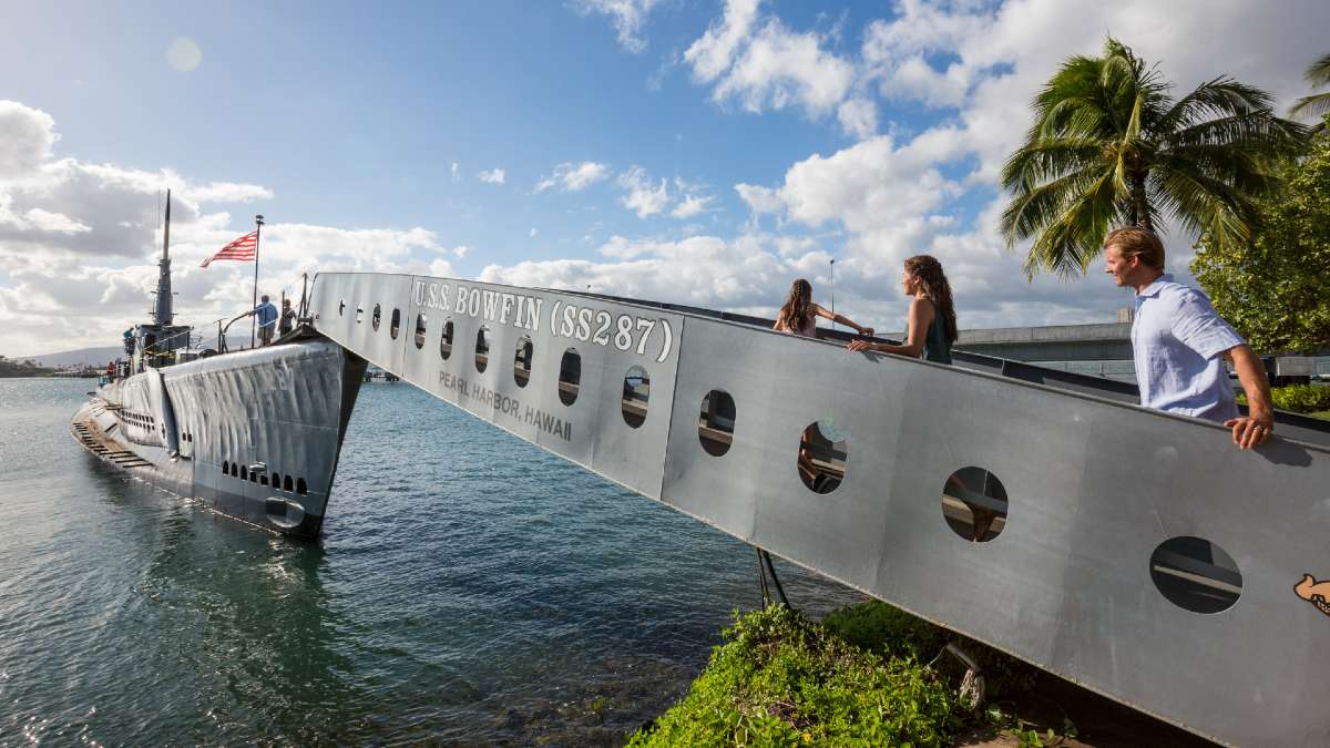 people walking across gangway to a ship