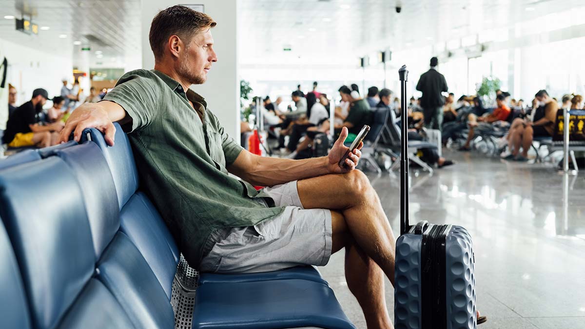 Man waiting at airport departure lounge