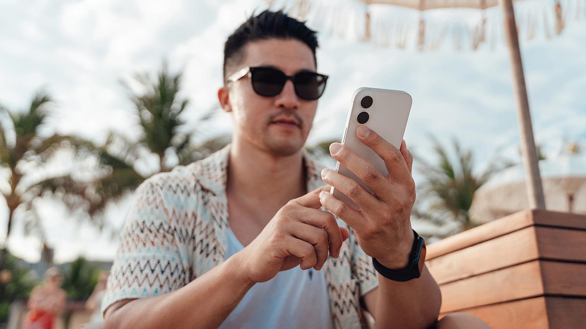 Man at resort in Bali looking at phone.