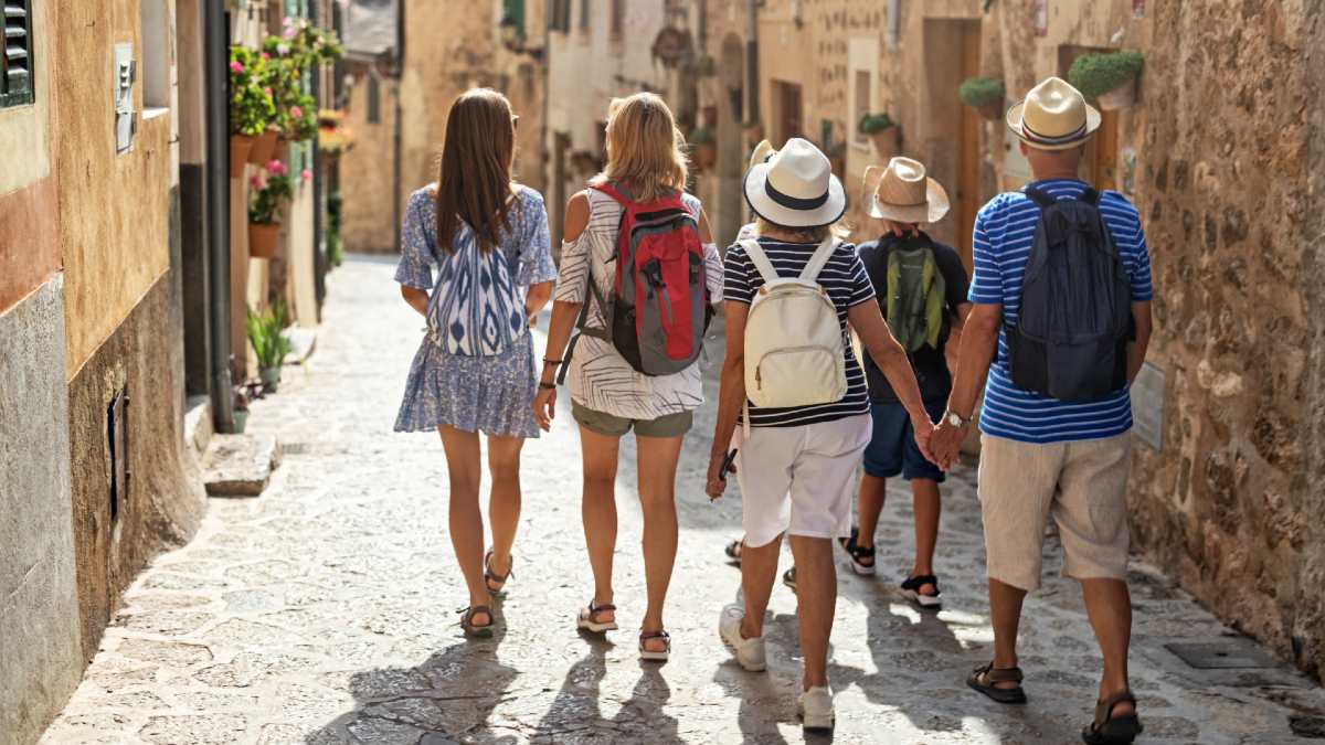 multi-generation family walking down a cobbled European street
