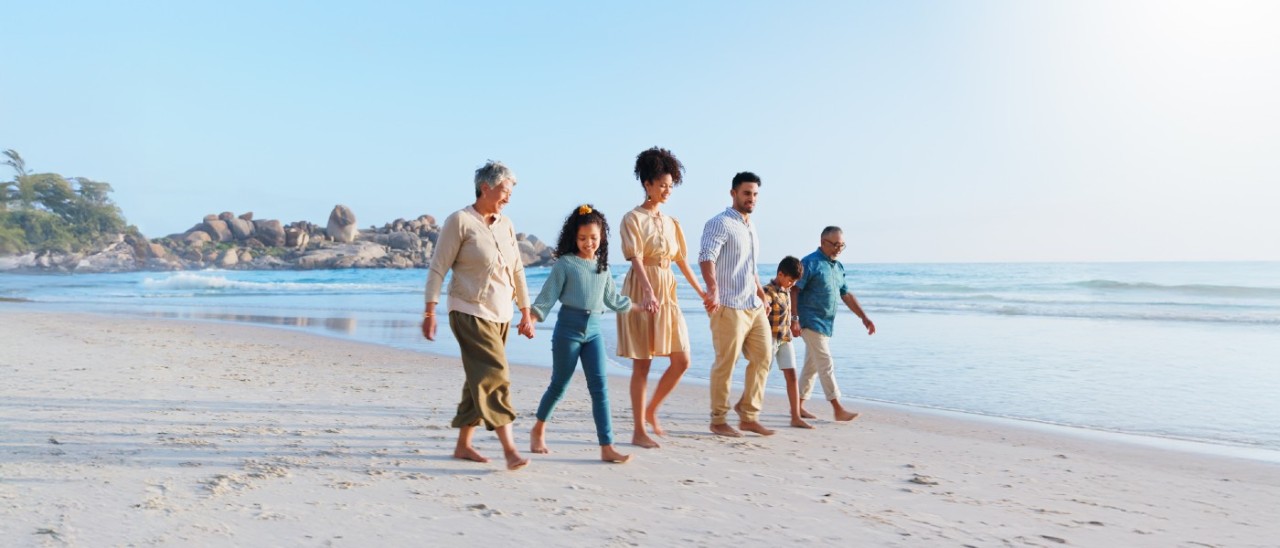 multi-generational family walking on beach
