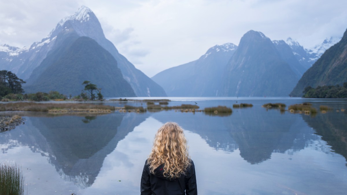woman looking at Milford Sound