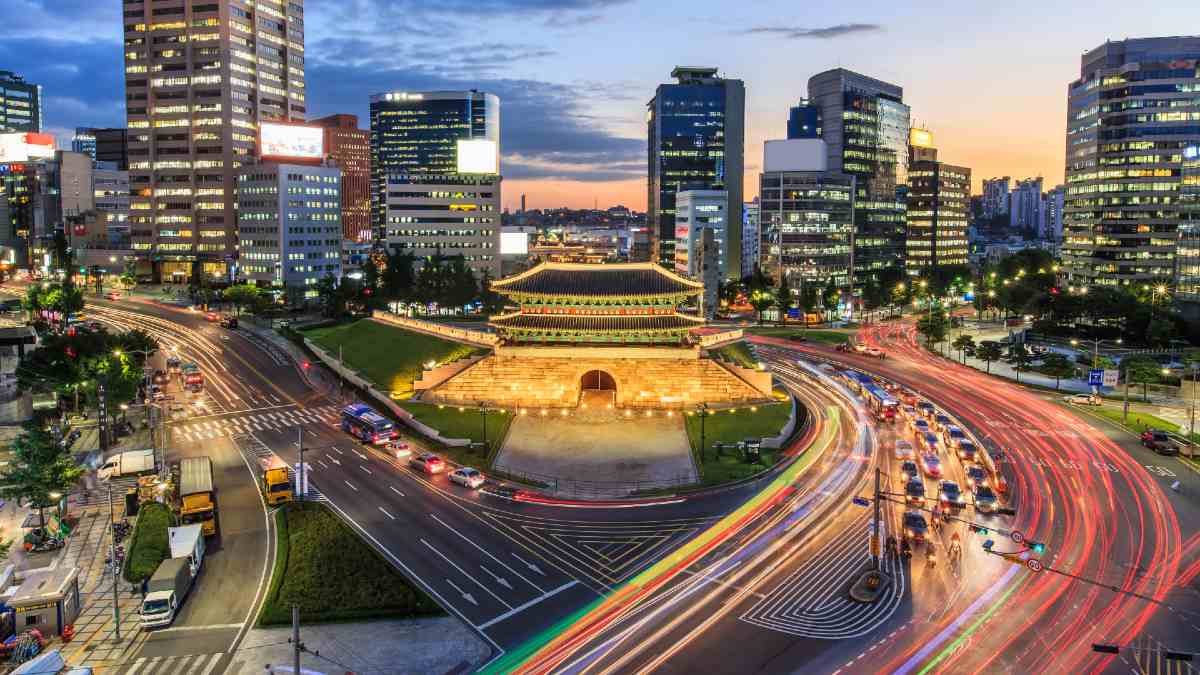 Korean city buildings and fortress surrounded by traffic