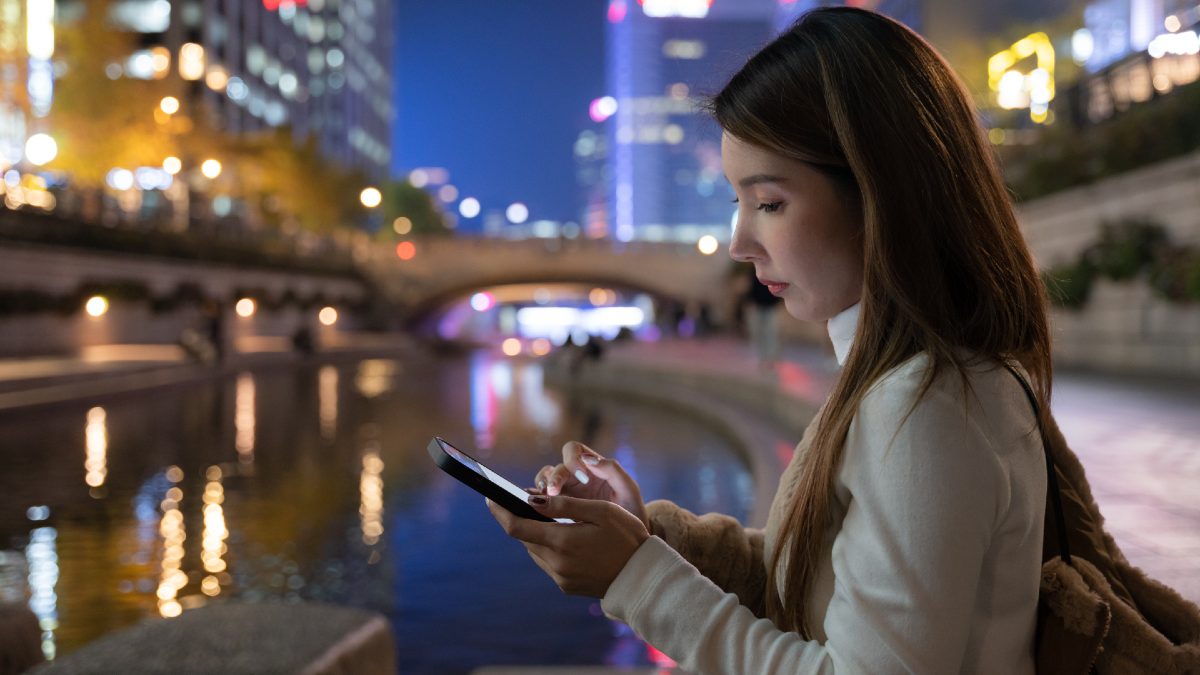 young woman using smartphone in Seoul