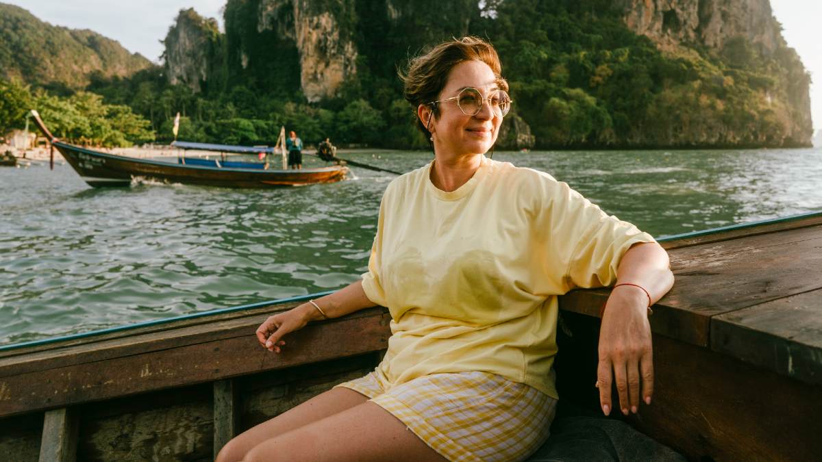 young woman on a Thai boat with islands in background