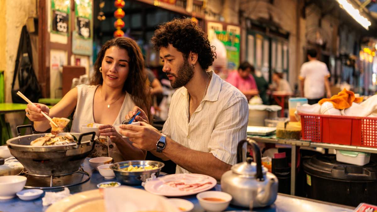 two tourists eating at a Thai Chinatown