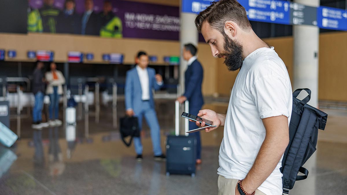Man using mobile phone at airport in Slovenia