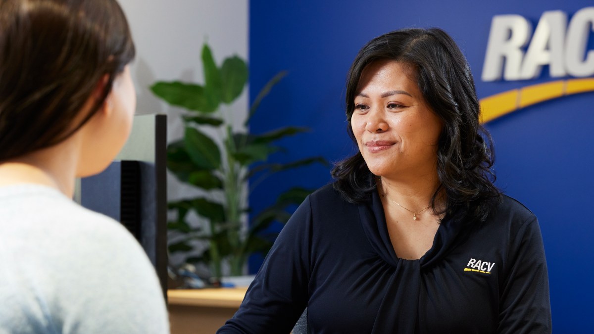 RACV travel agent looking at her computer with client sitting across from her