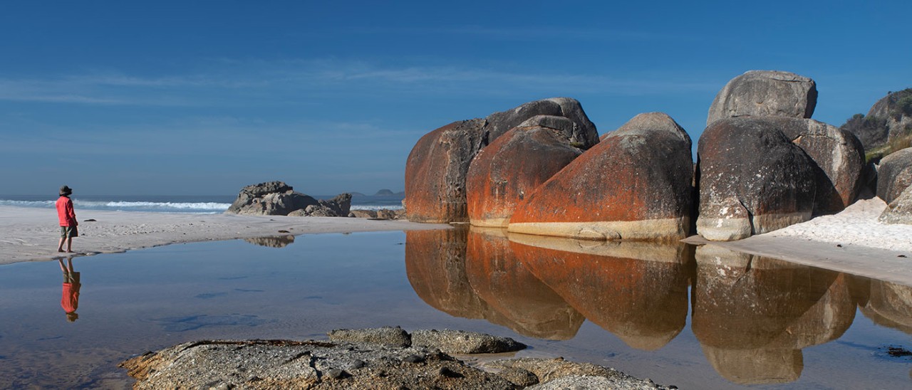 Person walking towards giant granite boulders at Squeaky Beach, Wilsons Promontory, Australia