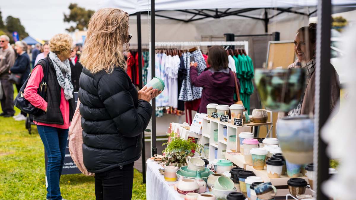 people shopping at an outdoor craft market
