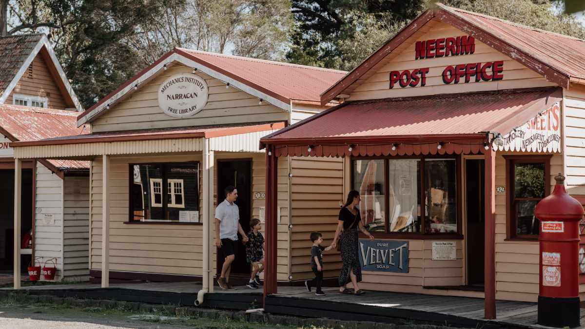 family walking through colonial-era buildings