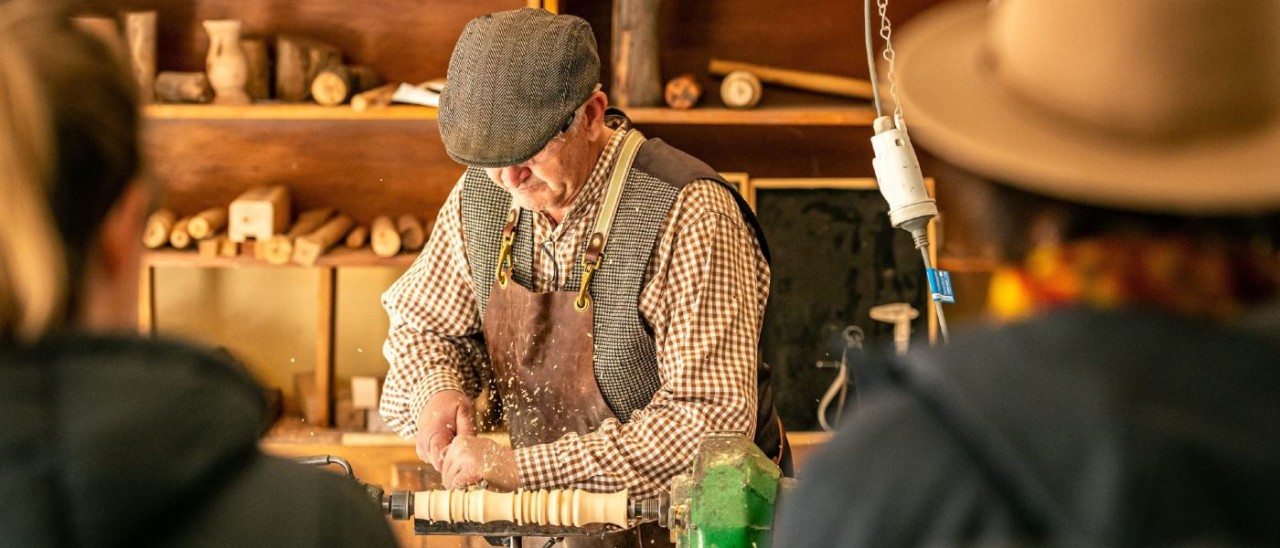 two people watching a woodturning demonstration