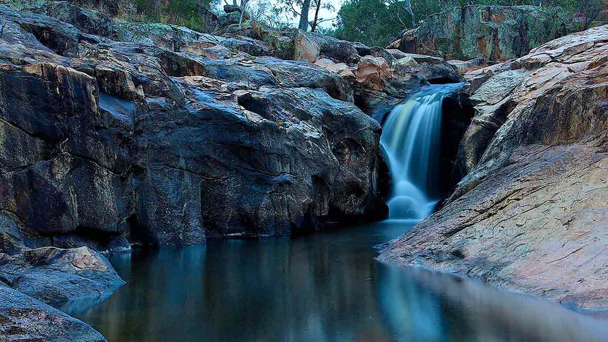 small waterfall among cliffs