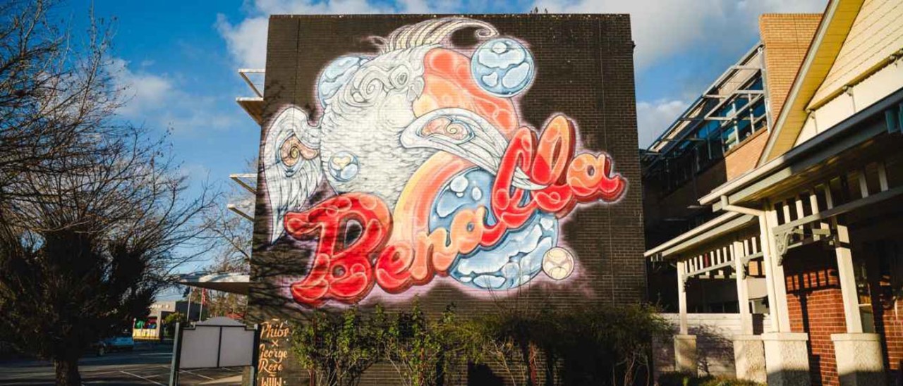 Artistic sign with Benalla written over abstract design to promote Benalla Street Art Festival