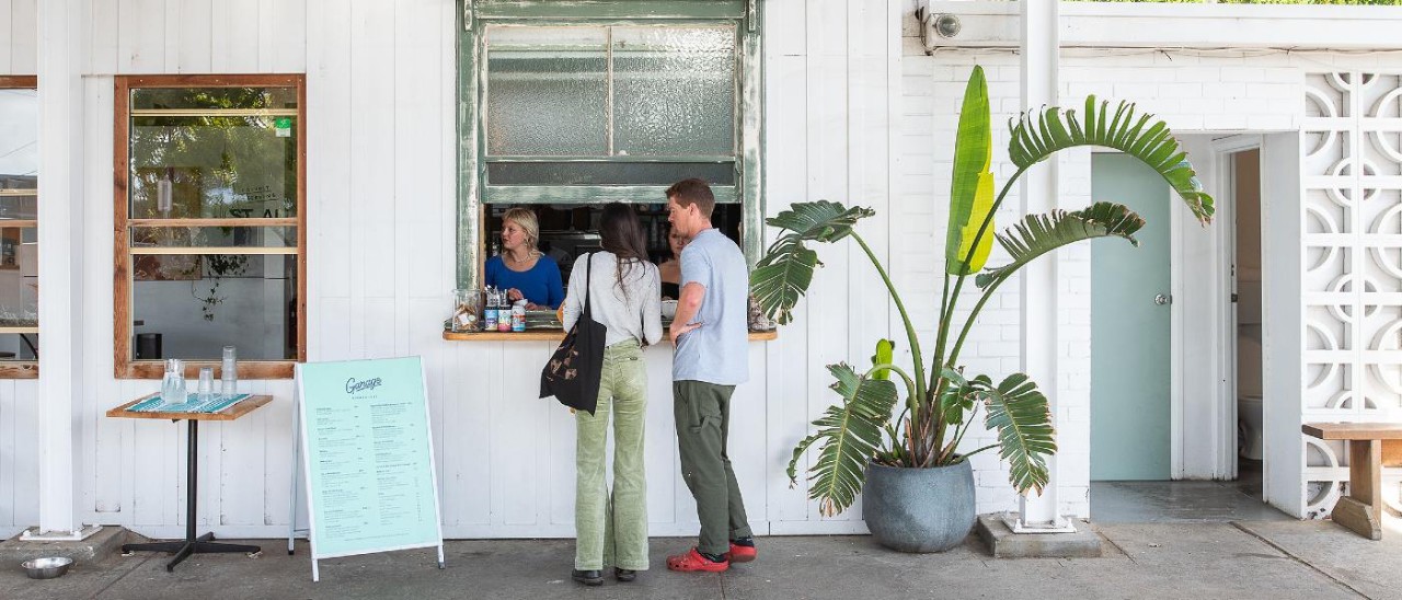 Garage Cafe, Ocean Grove_Visit Victoria man and woman ordering coffee from whitewashed building
